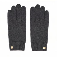 Pair of dark gray gloves with gold buttons on a white background