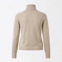 Beige turtleneck sweater on a light gray background