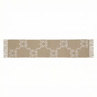 Beige table runner with white geometric pattern on a white background